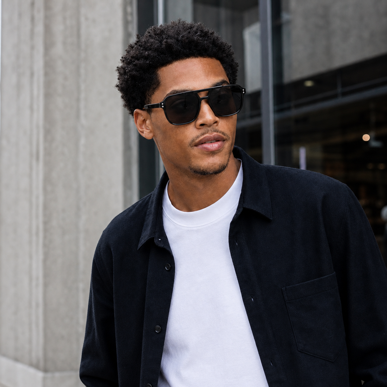 Young fashion model wearing NOCT Pillar oversized square navigator full-rim with double bridge sunglasses in Black / Smoke