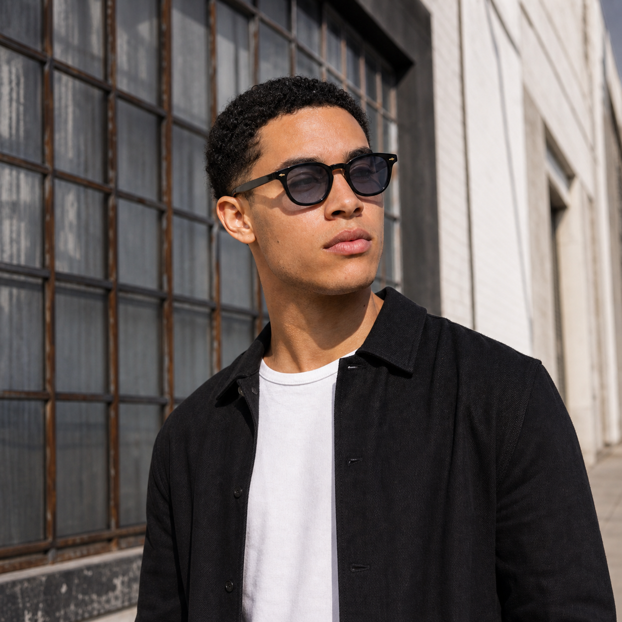 Young fashion model wearing NOCT Rune rounded square panto full-rim sunglasses in Black / Smoke