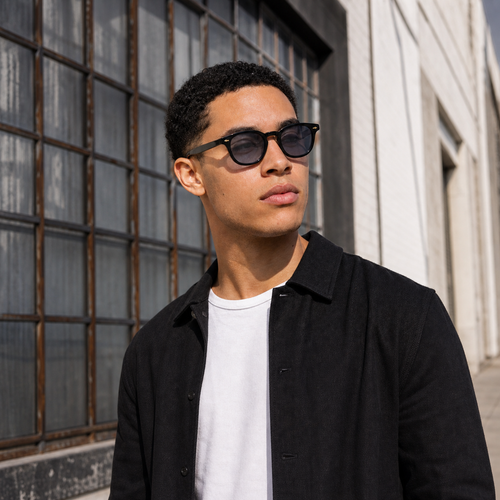 Young fashion model wearing NOCT Rune rounded square panto full-rim sunglasses in Black / Smoke