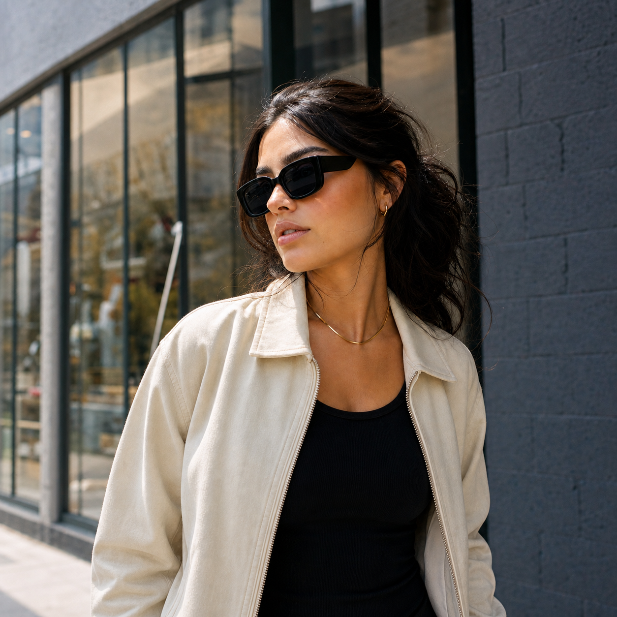 Young fashion model wearing NOCT Wraith narrow upswept rectangular full-rim sunglasses in Black / Smoke